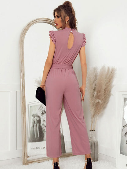 A model wearing the Sophia Women's Ruffled Jumpsuit featuring stylish ruffled sleeves, a high neckline, and a flattering tie-waist design, paired with wide-leg pants, showcasing an elegant and versatile outfit suitable for various occasions.