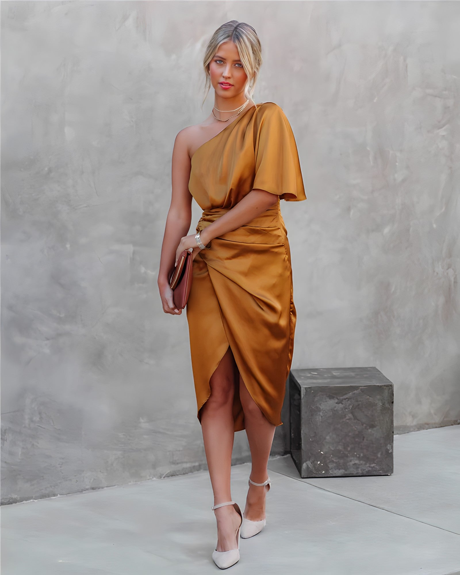 A woman standing in front of a decorated Christmas tree, wearing a stylish one-shoulder party dress with a ruched wrap design. The dress features an elegant silhouette, perfect for festive celebrations and special events. She is smiling and ready for the occasion.