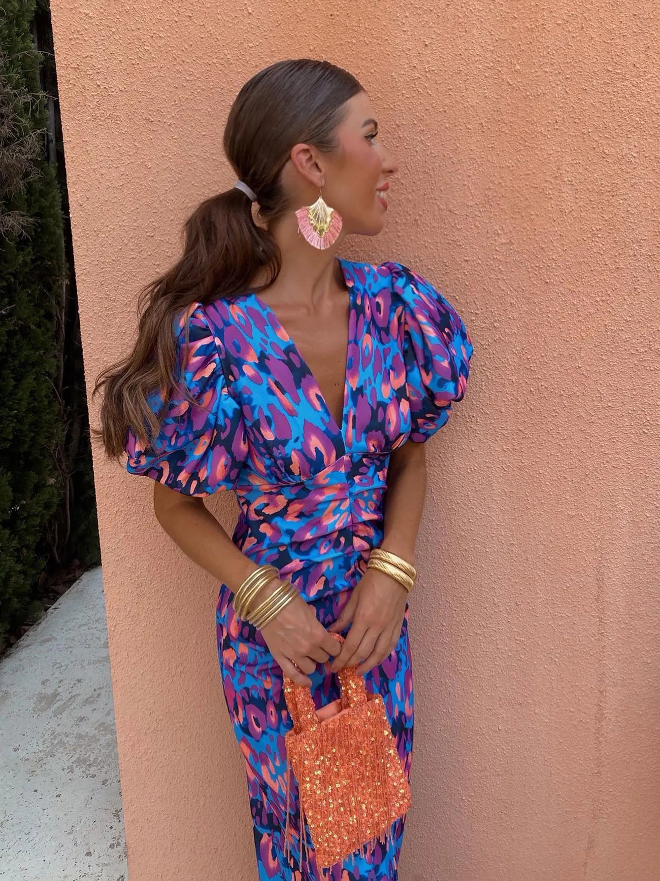 Model wearing the Amelia | Women's Statement Puff-Sleeve Dress | Vibrant Print Dress, featuring dramatic puff sleeves and a form-flattering design, paired with bold accessories for an elegant and stylish look.