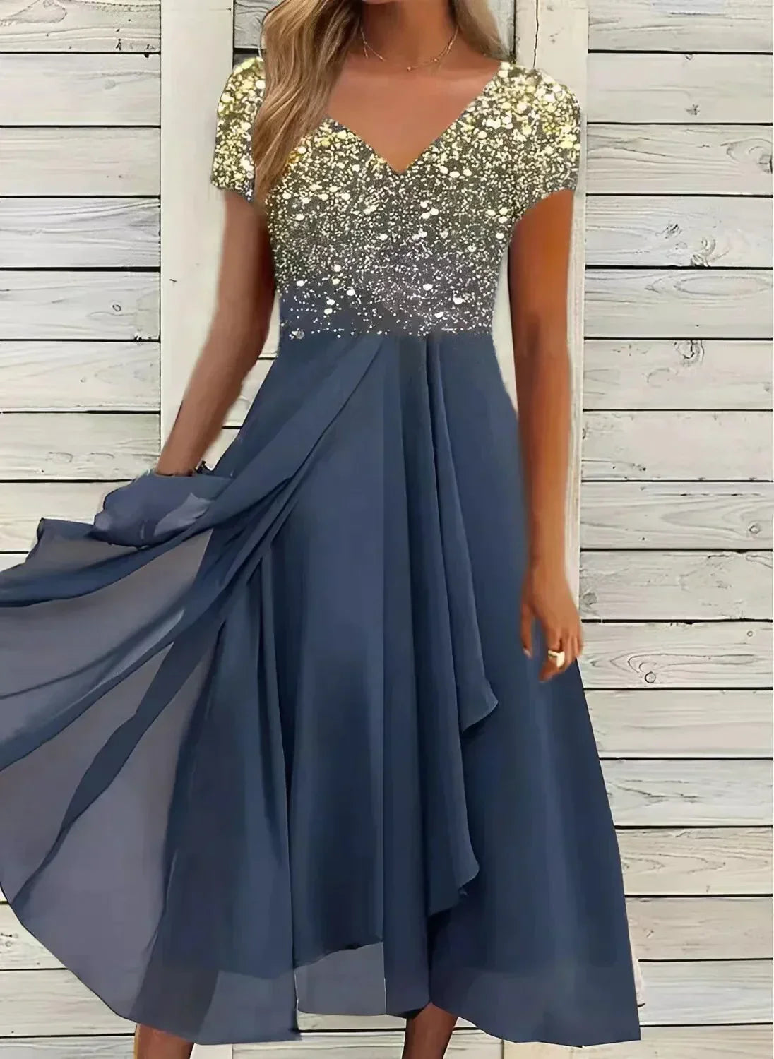 A woman wearing the Sienna Women's Sparkling Evening Dress, featuring a dazzling, sparkling bodice and a flowing midi-length skirt. This elegant dress is designed for formal events and special occasions, offering a graceful and glamorous look.