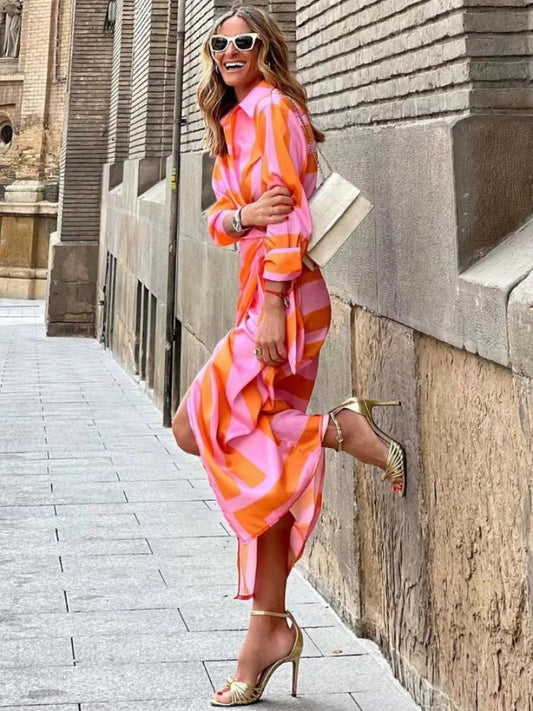 A stylish wrap dress with a striped pattern, featuring a fitted design and tied waist detail, perfect for casual or formal occasions, showcasing elegance and sophistication.
