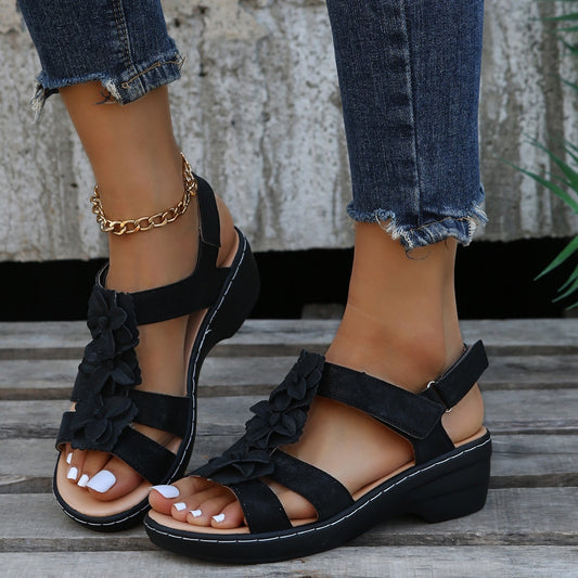 Image showing women's floral sandals with stylish strap design and floral embellishments, offering a comfortable wedge sole for casual wear.