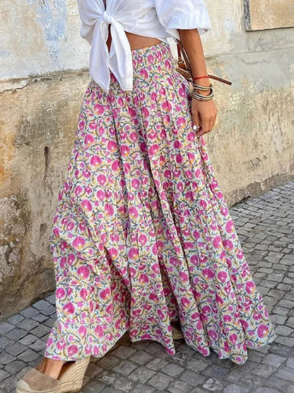 Stylish woman wearing a flowy maxi skirt with a bohemian pattern, paired with a tied blouse and accessories, showcasing a chic and effortless outfit perfect for casual and festive occasions.