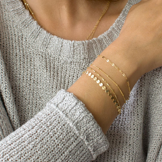 Close-up of the Emma Women's Layered Bracelet featuring multiple delicate layers with a minimalist chic design, worn on a wrist for an elegant and sophisticated look.