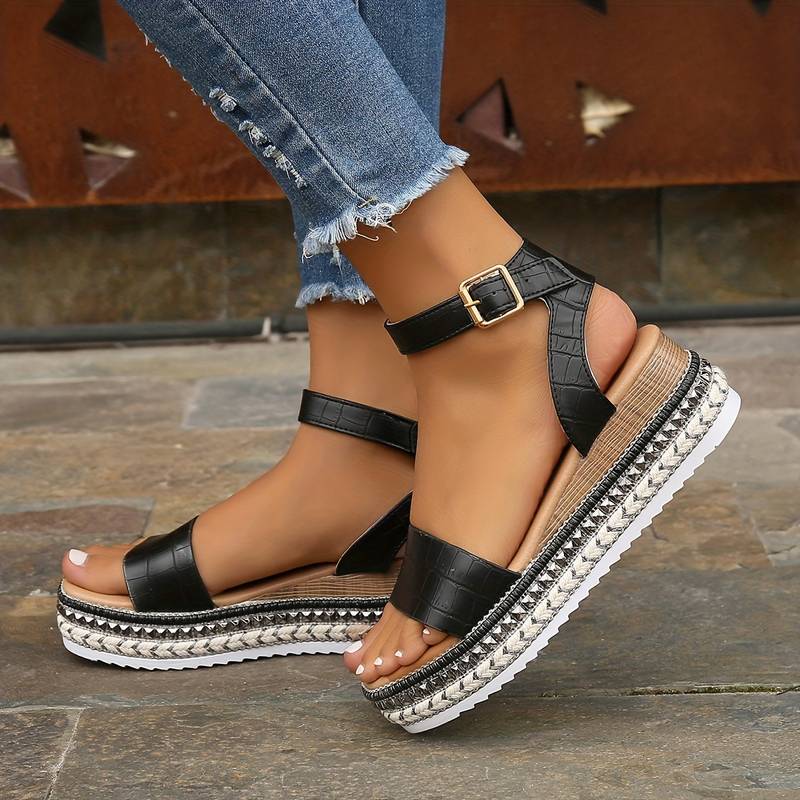 A close-up of a pair of Isabella Women's Chic Platform Sandals being worn, showcasing the elegant platform design with a secure buckle strap and textured detailing on the sole. These stylish sandals are ideal for adding height and sophistication to any casual or dressy outfit.