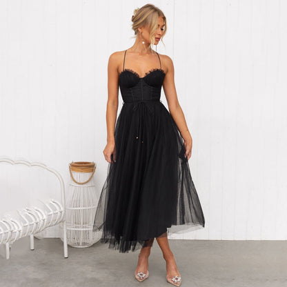 A woman wearing a stylish midi dress with a tulle skirt, fitted bodice, and delicate straps, posing gracefully in an elegant setting. The dress flows beautifully, creating a romantic and sophisticated look, perfect for special occasions.