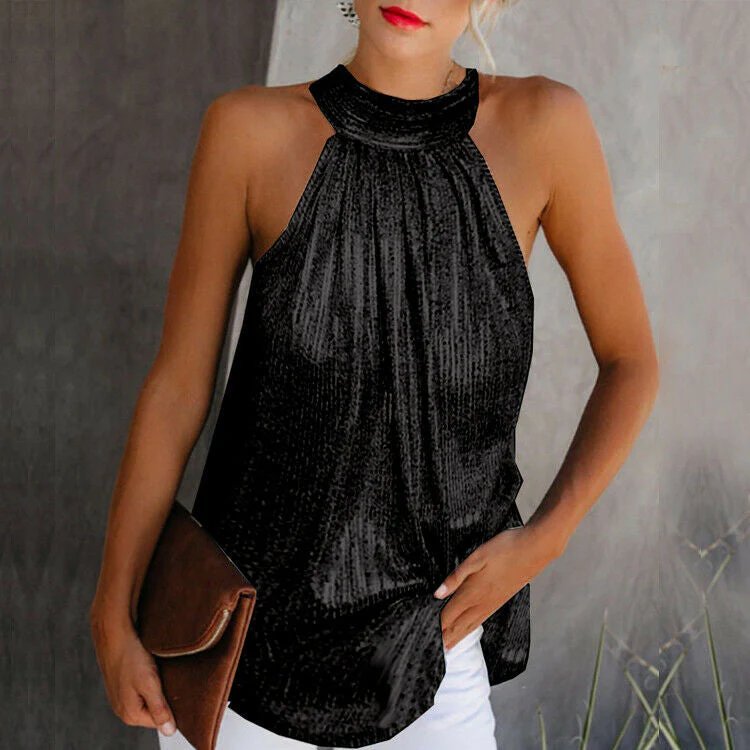 A stylish woman wearing an elegant halter top with pleated details, paired with white pants and accessorized with a clutch bag, showcasing a chic and sophisticated look.