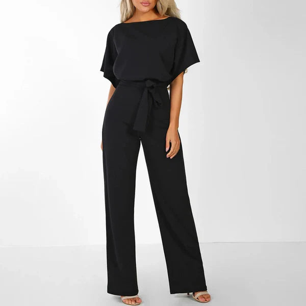 Model wearing the Jasmine | Stylish Wide-Leg Jumpsuit, featuring a flattering tie waist and wide-leg design. This chic jumpsuit is perfect for both casual and formal occasions, offering a comfortable yet stylish look.