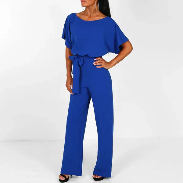 Model wearing the Jasmine | Stylish Wide-Leg Jumpsuit, featuring a flattering tie waist and wide-leg design. This chic jumpsuit is perfect for both casual and formal occasions, offering a comfortable yet stylish look.