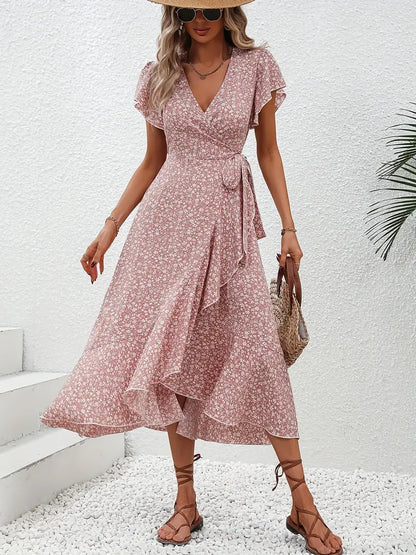 Model wearing the Lily | Flowy Wrap Midi Dress, featuring a flattering wrap design with flutter sleeves and a midi length. Perfect for casual outings and summer events, this dress offers a light, breezy, and feminine look.