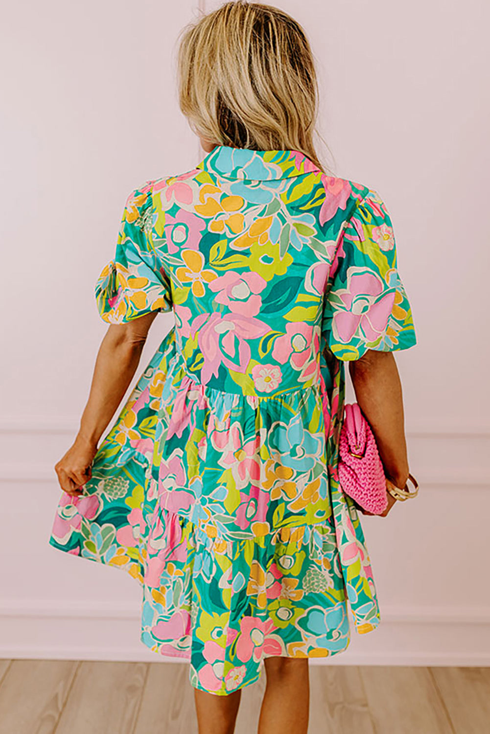 Back view of the Lily Women's Floral Tiered Dress, showcasing a vibrant floral pattern with tiered layers and short puff sleeves.