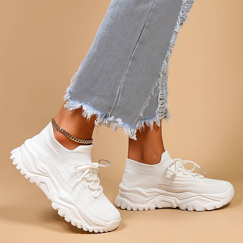 Image showcasing a pair of breathable women's sneakers with a sleek and lightweight design, featuring lace-up closure and a comfortable sole, ideal for casual wear and active lifestyles.