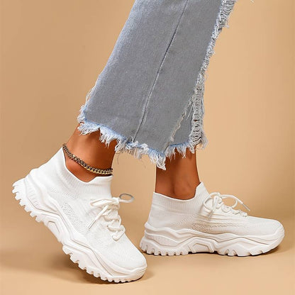 Image showcasing a pair of breathable women's sneakers with a sleek and lightweight design, featuring lace-up closure and a comfortable sole, ideal for casual wear and active lifestyles.