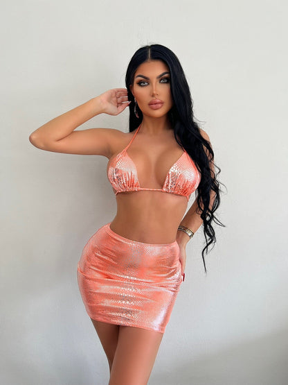 Model wearing the Mia | Bold Two-Piece Mini Skirt Set, featuring a daring bikini-style top and a form-fitting mini skirt. Perfect for a night out or special events, this set showcases a bold, confident look.