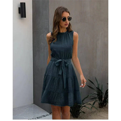 Back view of a woman wearing the Leah Women's Sleeveless Dress, a short dress with a flowy, tiered skirt, perfect for casual or semi-formal occasions.