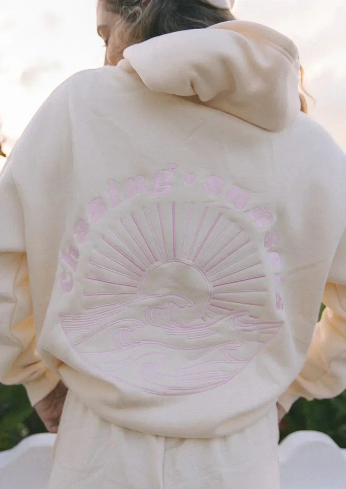 Back view of a woman wearing the Luna Women's Graphic Hoodie, showcasing a detailed graphic design with a relaxed fit, perfect for casual and cozy wear.