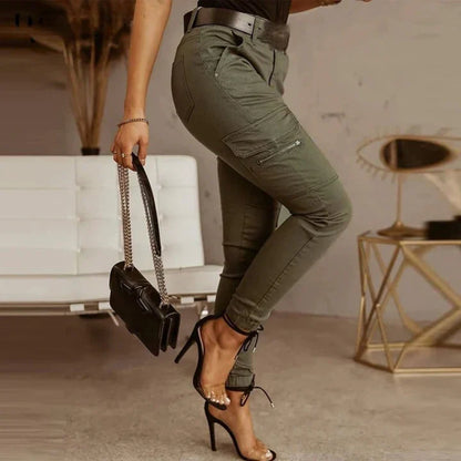 A woman wearing slim-fit high-waist cargo pants paired with heels, featuring functional side pockets and a belt for a chic, polished look. The pants have a fitted silhouette, ideal for both casual outings and dressier occasions.