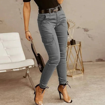 A woman wearing slim-fit high-waist cargo pants paired with heels, featuring functional side pockets and a belt for a chic, polished look. The pants have a fitted silhouette, ideal for both casual outings and dressier occasions.