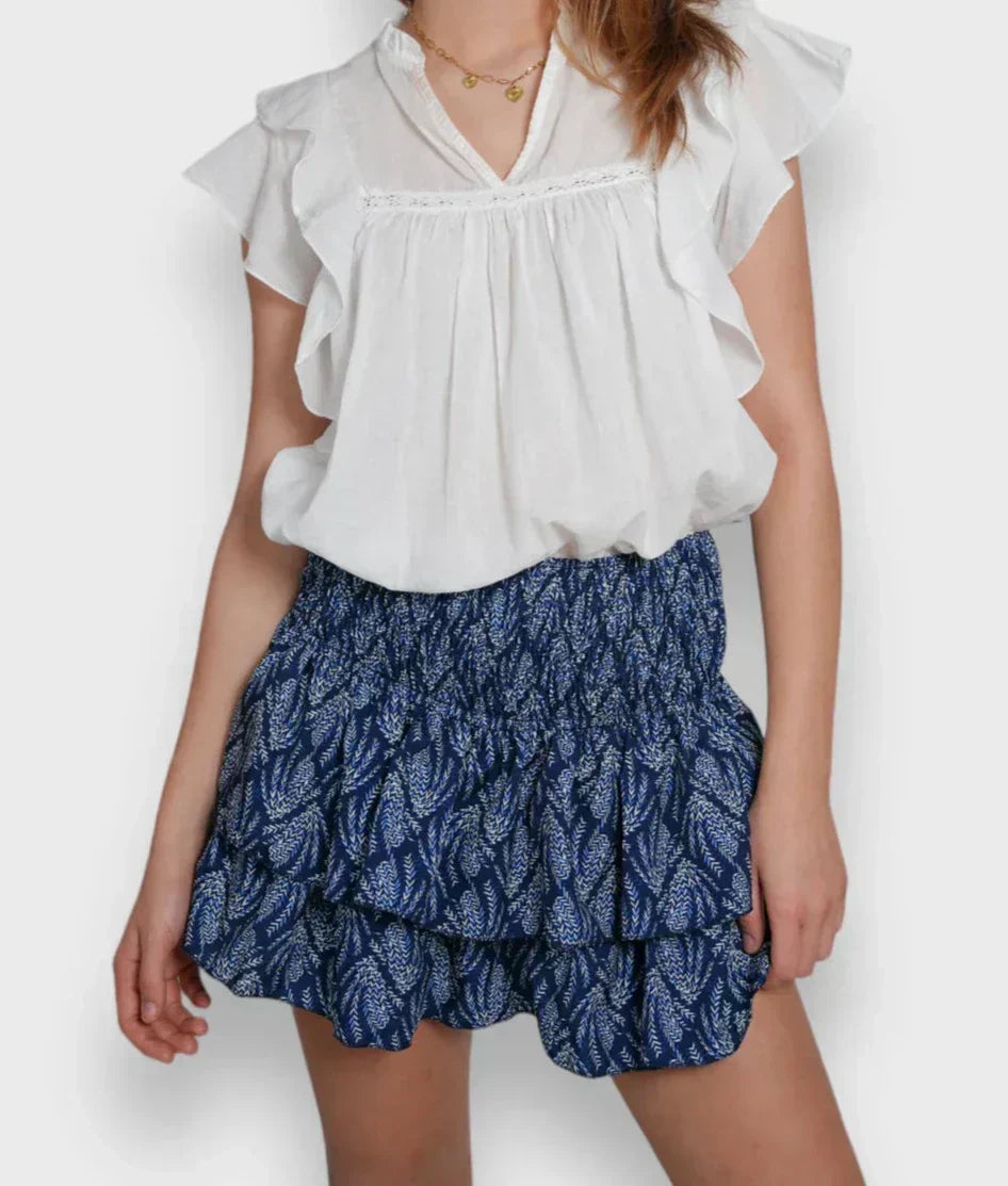 Close-up of the Ella | Tiered Ruffle Mini Skirt, showcasing its flattering smocked waistband and playful tiered ruffle design. Perfect for adding movement and style to any casual or dressed-up look.