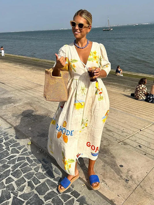 A fashionable woman taking a mirror selfie outdoors, wearing the Sophia | Women's Printed Midi Dress | Puff Sleeve Dress, styled with a woven bag, matching accessories, and flat sandals, showcasing the dress's elegant design and comfortable fit.