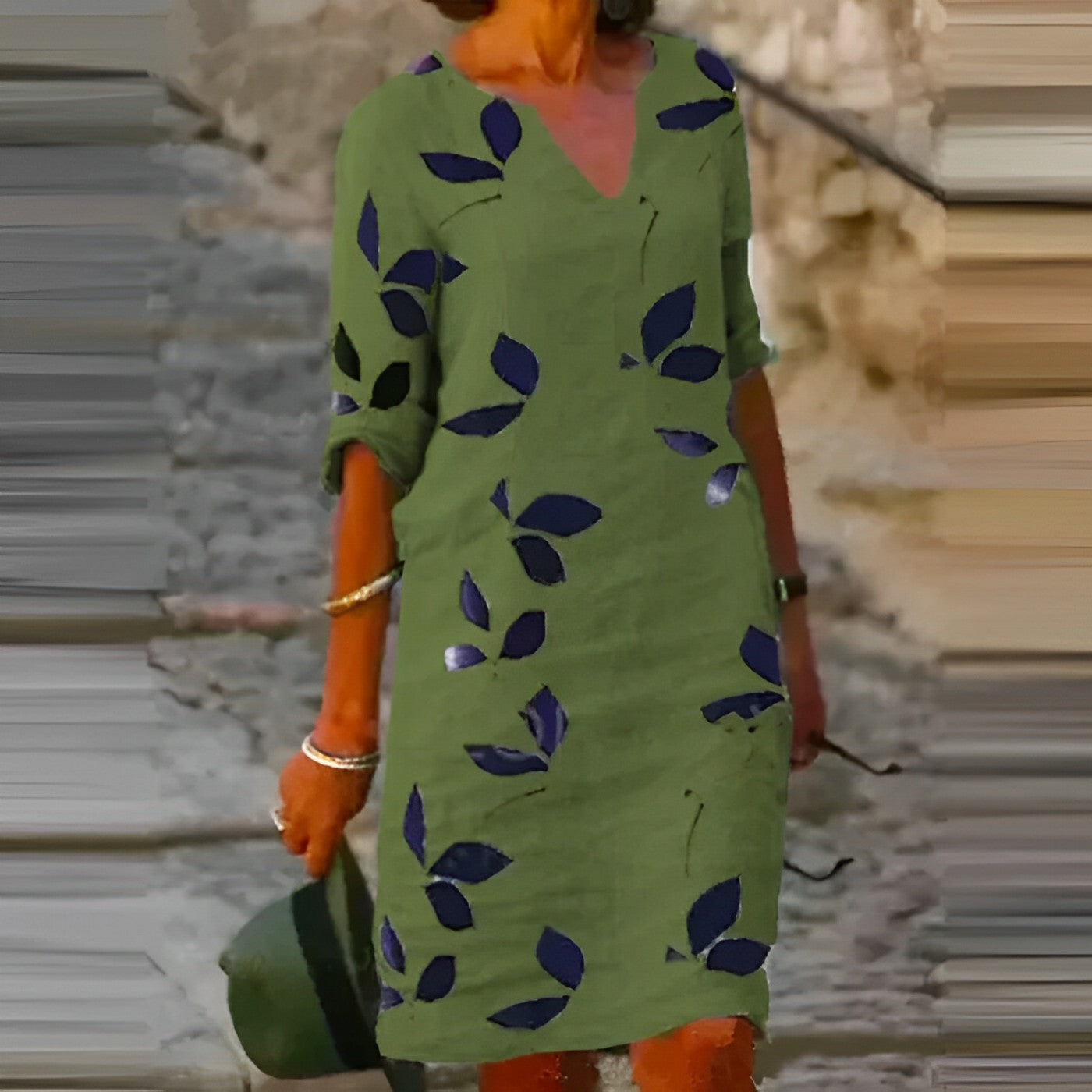 A woman wearing the Sophie Women's Leaf Print Shift Dress with an elegant V-neckline and a stylish leaf pattern. This dress features a relaxed, comfortable fit, ideal for casual or semi-formal occasions, offering a chic and nature-inspired look.