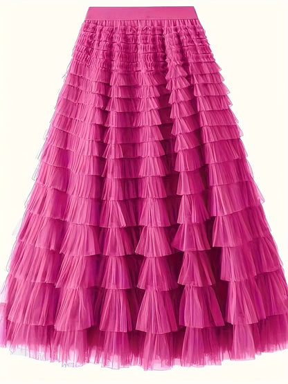 Woman wearing the Sophie Women's Layered Tulle Skirt, a ruffled skirt with multiple soft layers, creating a flowing and voluminous look, styled with a sleeveless top and accessories, standing on steps outdoors.