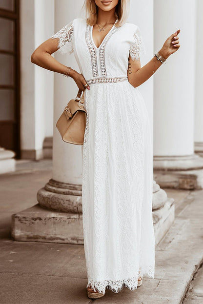 Woman wearing the Scarlett Women's Lace Maxi Dress, a bohemian-inspired dress featuring intricate lace details, a fitted bodice, and flowing skirt, accessorized with a wide-brim hat, creating a chic, free-spirited look.