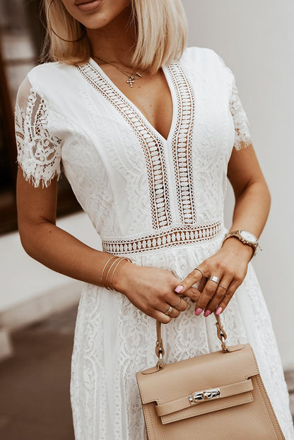 Woman wearing the Scarlett Women's Lace Maxi Dress, a bohemian-inspired dress featuring intricate lace details, a fitted bodice, and flowing skirt, accessorized with a wide-brim hat, creating a chic, free-spirited look.