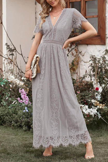 Woman wearing the Scarlett Women's Lace Maxi Dress, a bohemian-inspired dress featuring intricate lace details, a fitted bodice, and flowing skirt, accessorized with a wide-brim hat, creating a chic, free-spirited look.