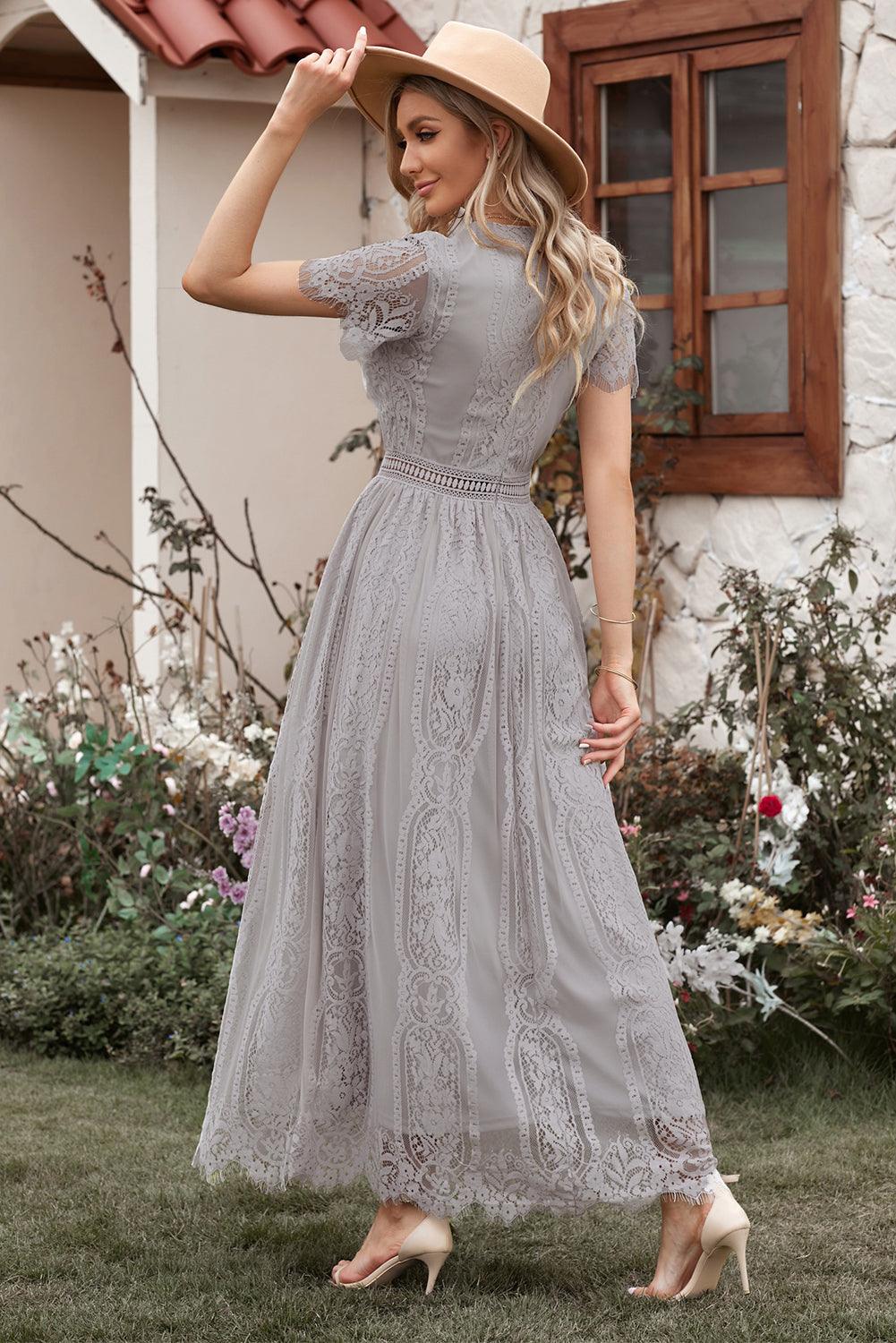 Woman wearing the Scarlett Women's Lace Maxi Dress, a bohemian-inspired dress featuring intricate lace details, a fitted bodice, and flowing skirt, accessorized with a wide-brim hat, creating a chic, free-spirited look.