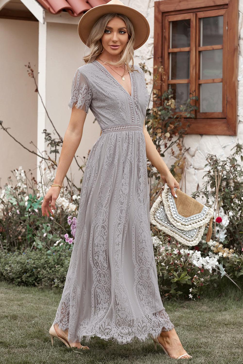 Woman wearing the Scarlett Women's Lace Maxi Dress, a bohemian-inspired dress featuring intricate lace details, a fitted bodice, and flowing skirt, accessorized with a wide-brim hat, creating a chic, free-spirited look.