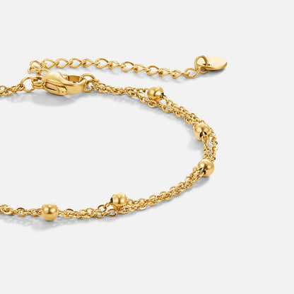Smiling woman showcasing the Emily Women's Delicate Bracelet on her wrist, highlighting its minimalist design and elegant details. A perfect accessory for adding subtle sophistication to any outfit.