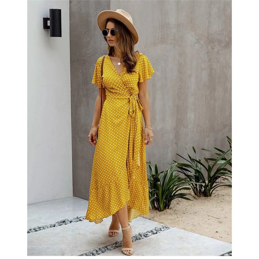 Image of a woman wearing the Mila Women's Flowy Wrap Dress, a stylish midi dress with a wrap design, flutter sleeves, and a flowing skirt, perfect for casual and semi-formal occasions. The dress exudes effortless elegance and complements any outdoor or relaxed setting.