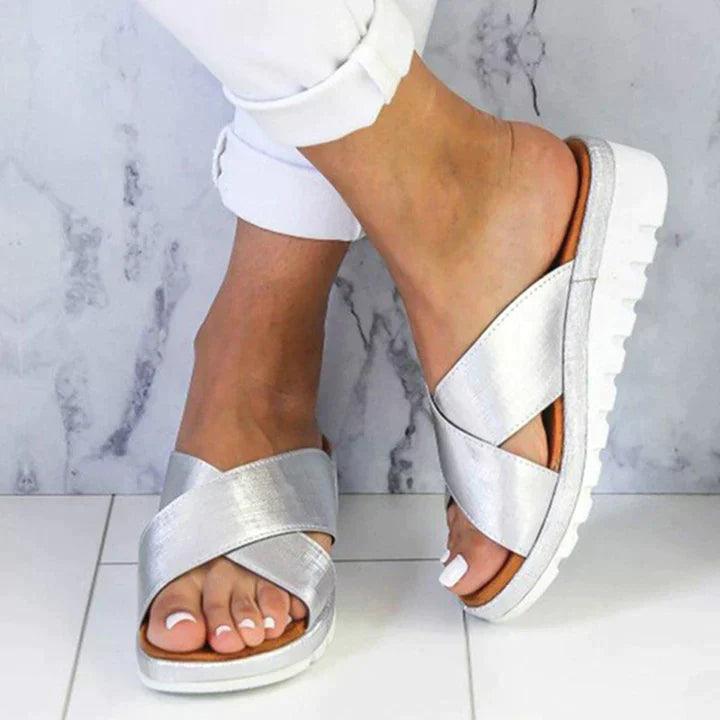 Image showing women's casual sandals with a crisscross strap design, offering a comfortable fit and ideal for casual outings or relaxed wear.