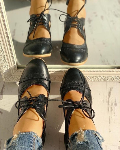Elegant women's heeled shoes with lace-up detailing and a timeless design, paired with denim pants. Perfect for casual or formal occasions.