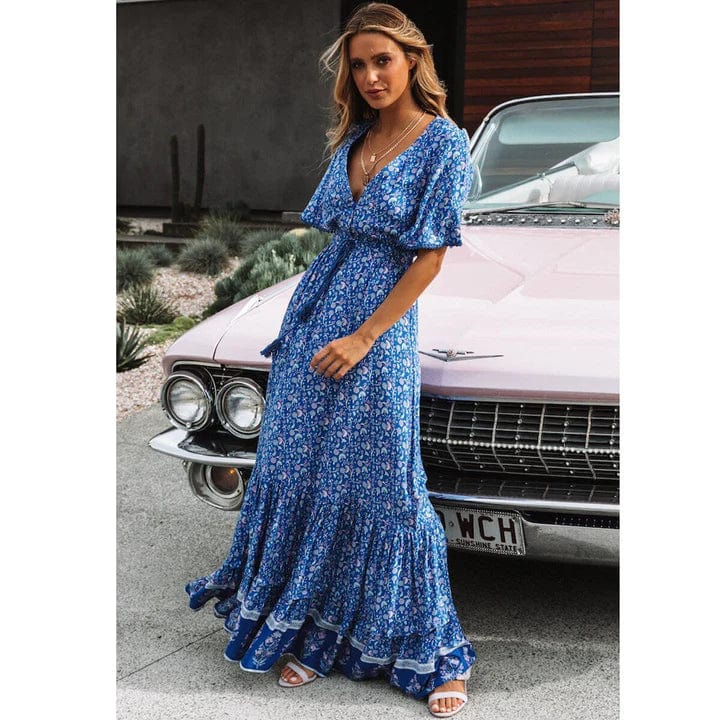 Woman wearing the Sabrina Women's Bohemian Maxi Dress, a flowing ruffled dress with a relaxed, bohemian style, posing gracefully in front of a classic car, exuding a free-spirited and elegant vibe.