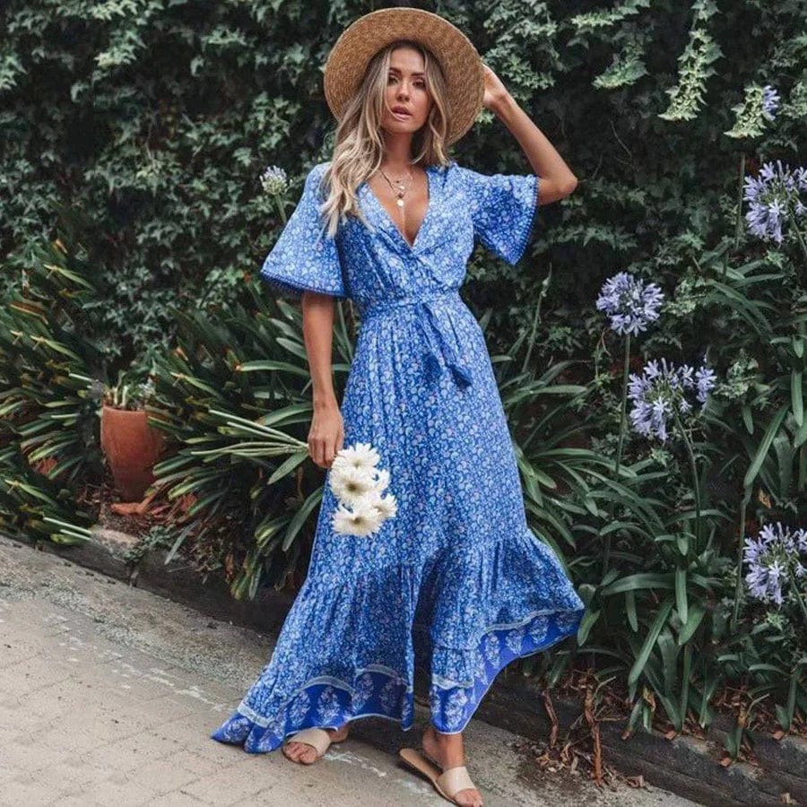 Woman wearing the Sabrina Women's Bohemian Maxi Dress, a flowing ruffled dress with a relaxed, bohemian style, posing gracefully in front of a classic car, exuding a free-spirited and elegant vibe.