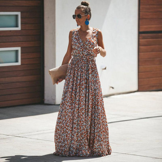 Woman wearing the Emily Women's Flowing Maxi Dress, a long, elegant dress with a flattering fit, accessorized with statement earrings, sunglasses, and a clutch bag, standing outdoors in a stylish, relaxed pose.