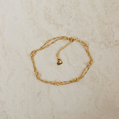 Close-up of a model wearing the Sofia Women's Delicate Bracelet, featuring a minimalist and elegant design, perfect for adding a subtle touch of sophistication to any outfit.