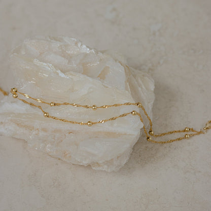 Close-up of a model wearing the Sofia Women's Delicate Bracelet, featuring a minimalist and elegant design, perfect for adding a subtle touch of sophistication to any outfit.