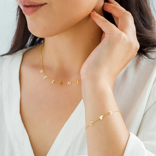 Close-up of a model wearing the Elena Women's Personalized Bracelet featuring a custom name design, paired with a matching personalized necklace for a chic and meaningful look.