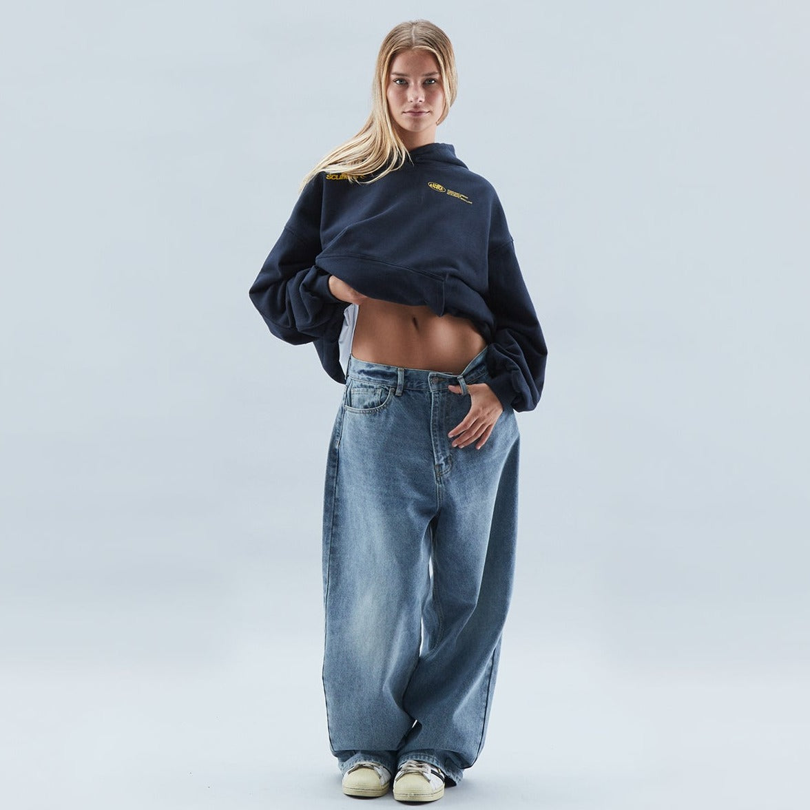 A person wearing the Harper Women's Oversized Hoodie paired with relaxed-fit jeans, showcasing the casual and comfortable style of the hoodie.