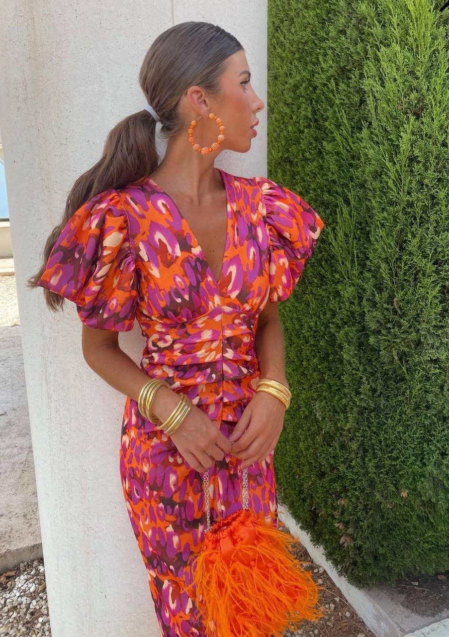 Model wearing the Amelia | Women's Statement Puff-Sleeve Dress | Vibrant Print Dress, featuring dramatic puff sleeves and a form-flattering design, paired with bold accessories for an elegant and stylish look.