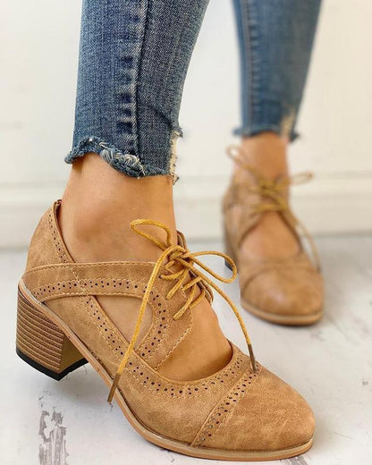 Elegant women's heeled shoes with lace-up detailing and a timeless design, paired with denim pants. Perfect for casual or formal occasions.