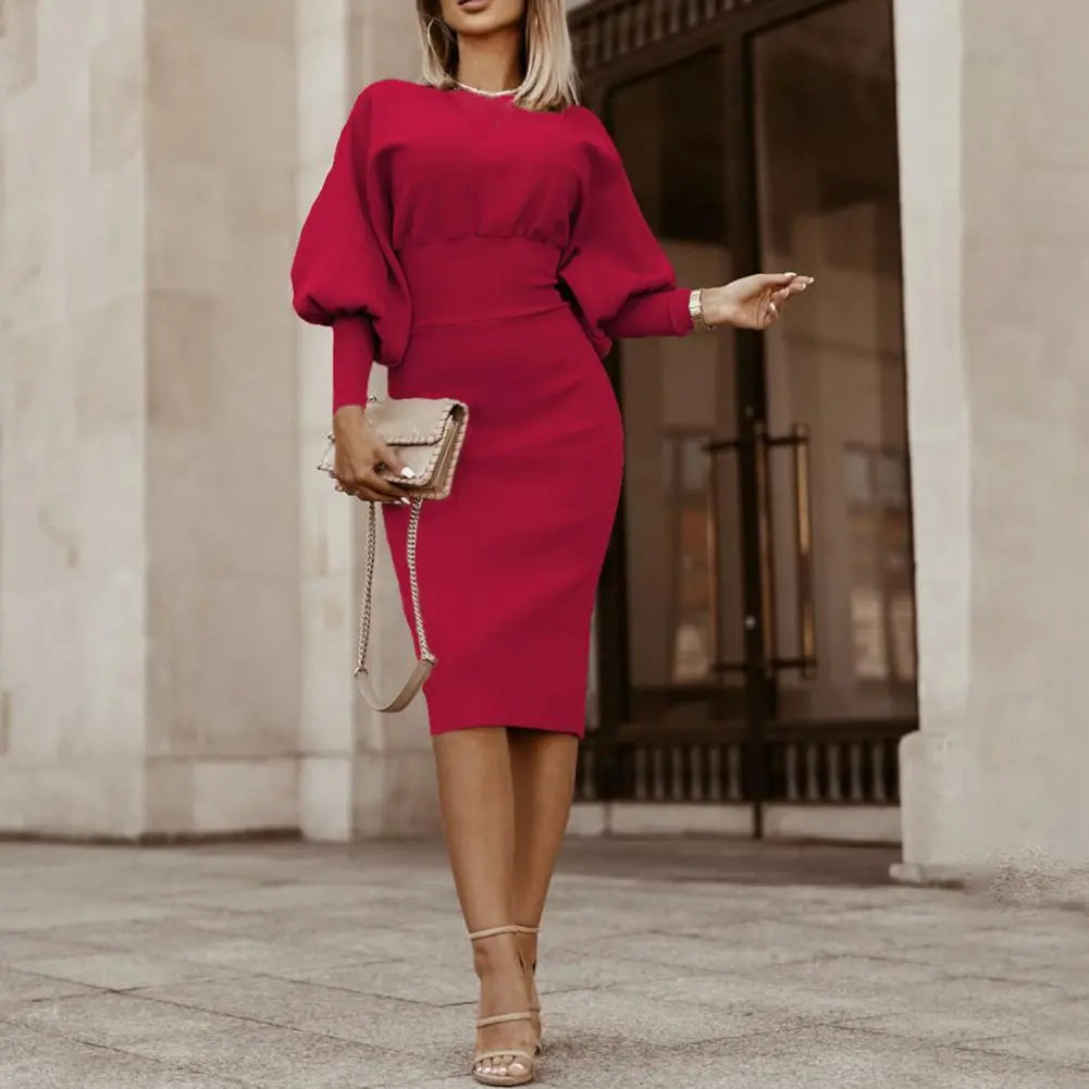 A stylish woman wearing the Sophia | Women's Elegant Midi Dress | Puff Sleeve Dress, showcasing its fitted silhouette, puff sleeves, and refined midi length, ideal for formal or semi-formal occasions.