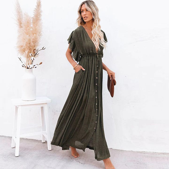 Woman wearing the Sienna Women's Button-Down Maxi Dress, a long, flowing dress with a relaxed fit and button-down front, posing elegantly with her hand in a pocket, holding a clutch, against a minimalist background.