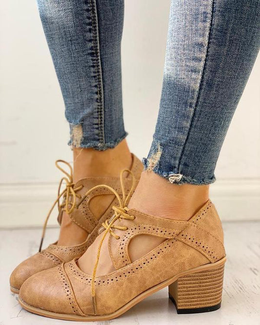 Elegant women's heeled shoes with lace-up detailing and a timeless design, paired with denim pants. Perfect for casual or formal occasions.