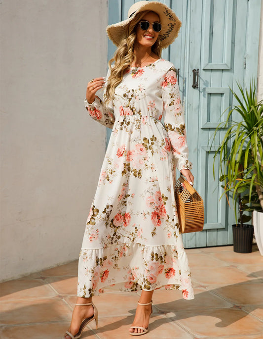 Woman wearing the Camilla Women's Floral Maxi Dress, a long dress with a flowy silhouette and elegant floral design, styled with long sleeves and paired with strappy heels, standing outdoors in a sunny, stylish setting.