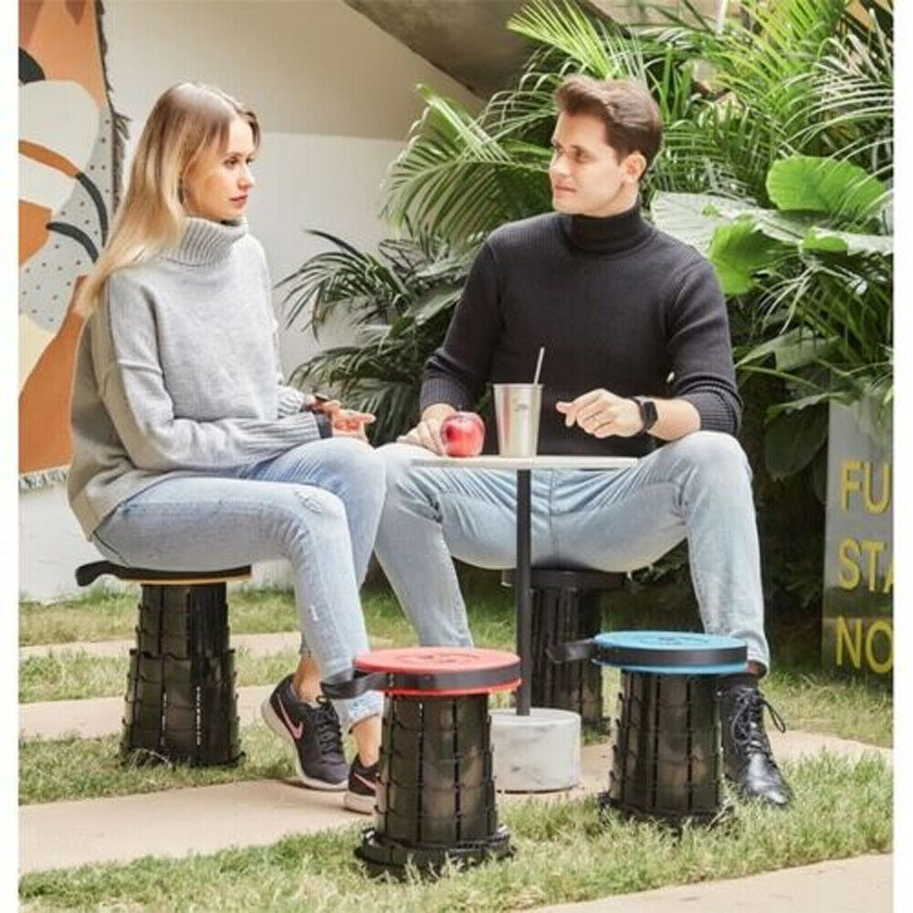 Two people sitting on adjustable camping stools while fishing near a tent, showcasing the stool's portable and sturdy design for outdoor comfort.