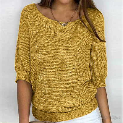 Image of a woman wearing an elegant relaxed fit sweater, featuring a chic design perfect for casual and stylish occasions.